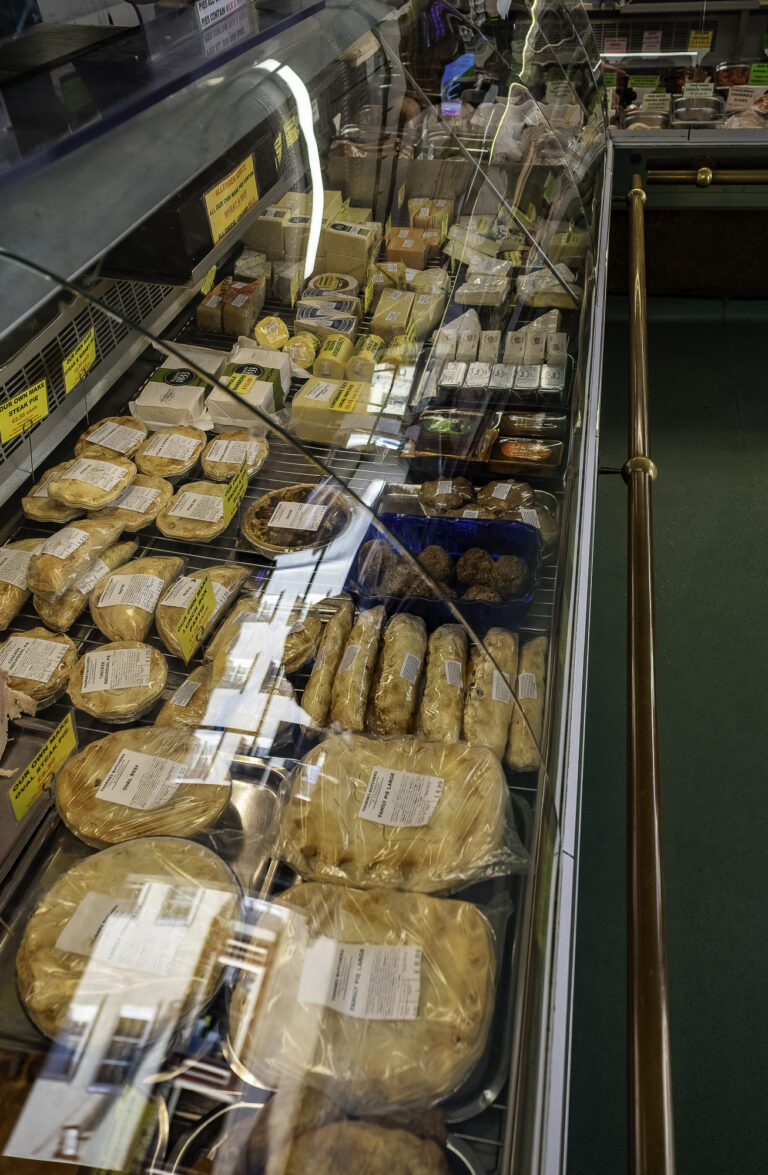 Display of homemade pies and pasties inside butcher's shop