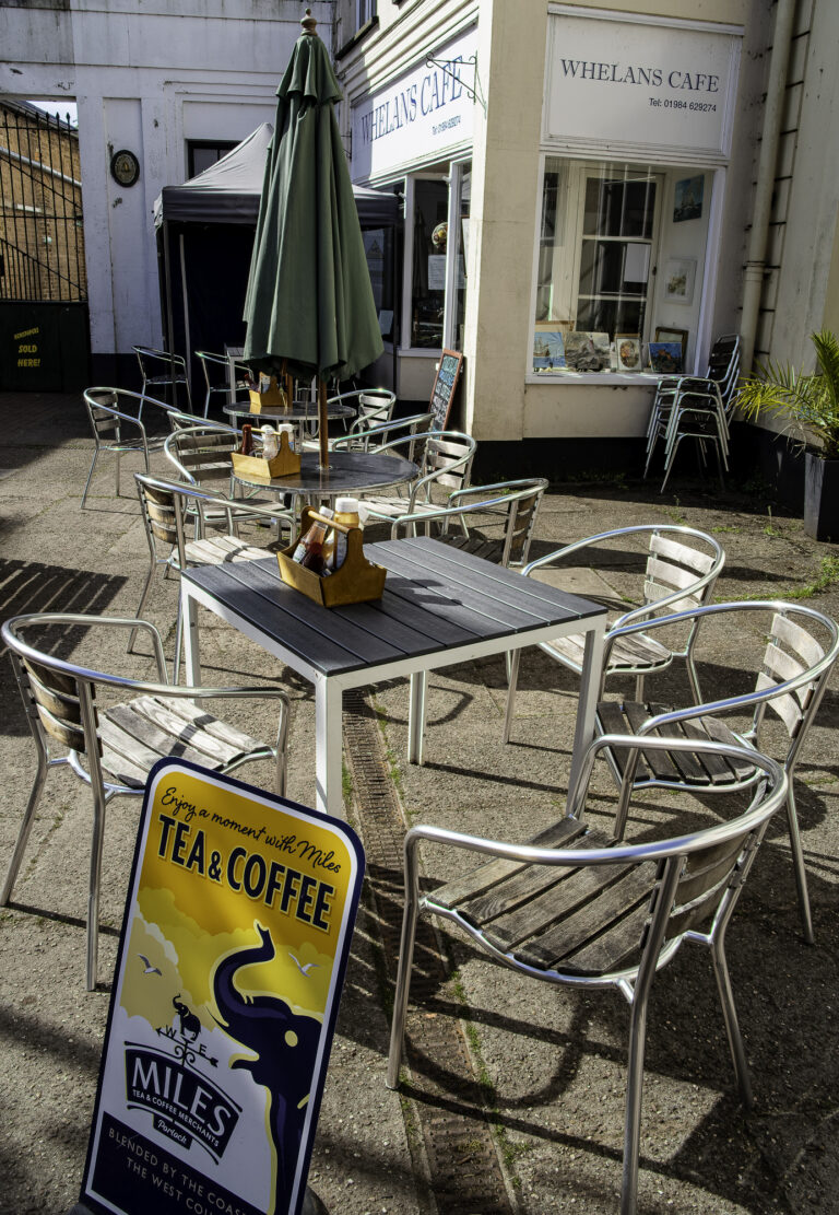 Tables and chairs in the town square in sunshine outside Whelan's cafe
