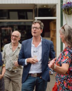 William Sitwell holding a beer glass and chatting with visitors to the annual RestFest.