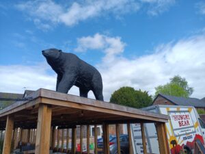 Picture of giant black bear sculpture on the roof of the beer garden pergola at The Bear pub